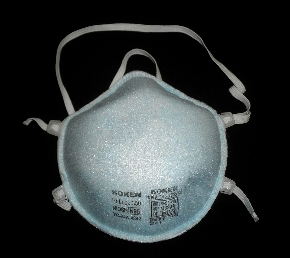 A cup-style respirator with two elastic straps, its face stamped NIOSH N95